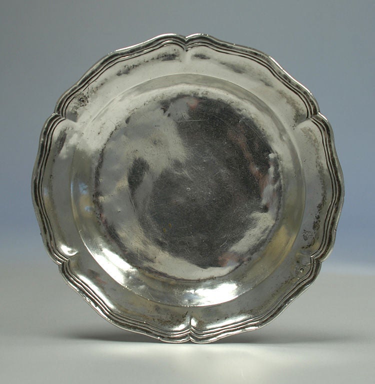 18th century Spanish colonial silver plate with scalloped edge, visible center mark, owner's mark, and good age tarnished patina throughout. 360 grams.