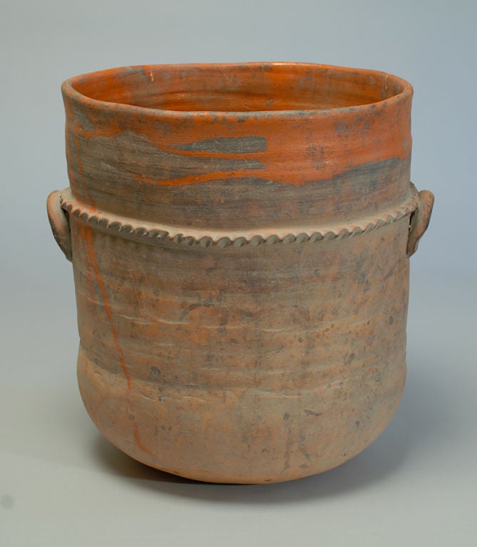 A large antique Mexican terra-cotta pot with handles, ribbed bands and a deep tomato red glaze - circa 1900.<br />
<br />
Dimensions: 16.5 inches high x 14.5 inches diameter.