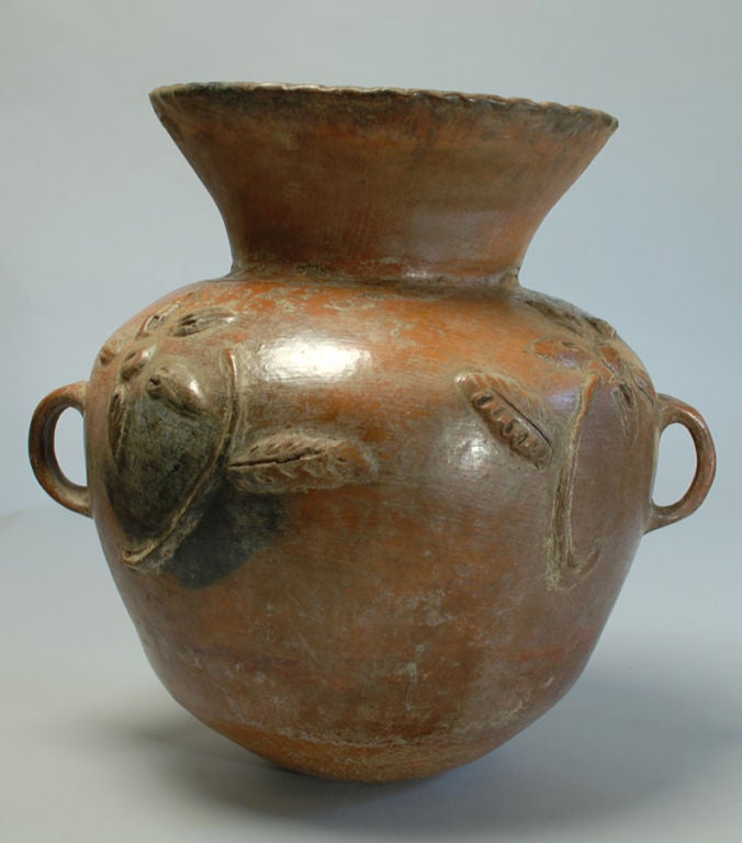 A large antique Guatemalan Florera (flower pot) with raised foliate motifs and traces of an old painted surface - circa 1900. <br />
<br />
Dimensions: 18 inches tall x 18 inches diameter (handle to handle)