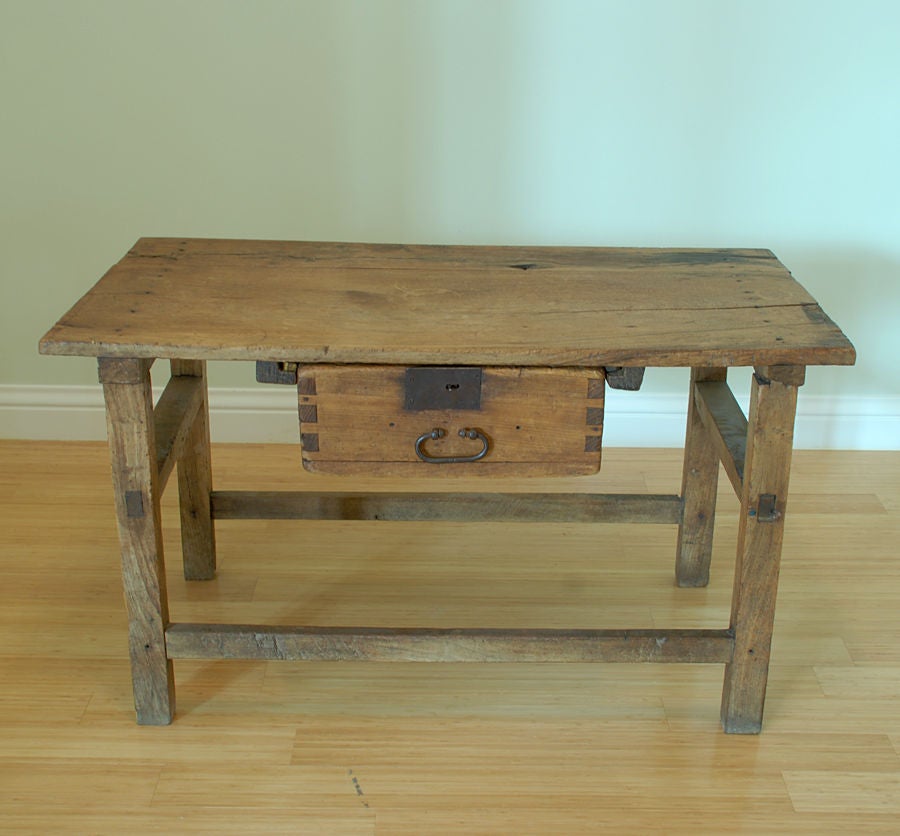 A charming 19th century Mexican mesquite wood tavern table with single hanging drawer. 

Dimensions: 44 inches x 21.5 inches deep x 26 inches high