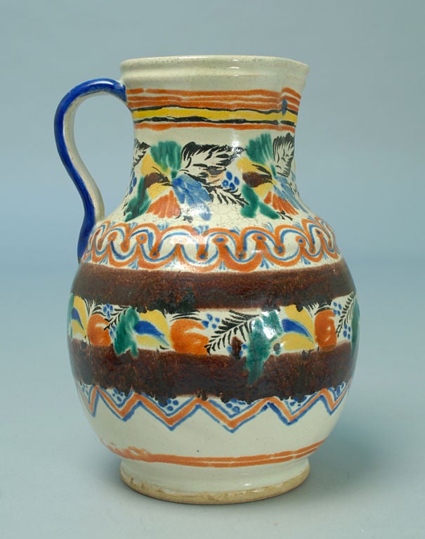 A beautiful 19th century handled Talavera jar from Mexico. Glazed all over in deep shades of copper green, blue, terra-cotta, black, yellow and aubergine with a heavily cracquelured surface.<br />
<br />
Dimensions: 11 inches high.
