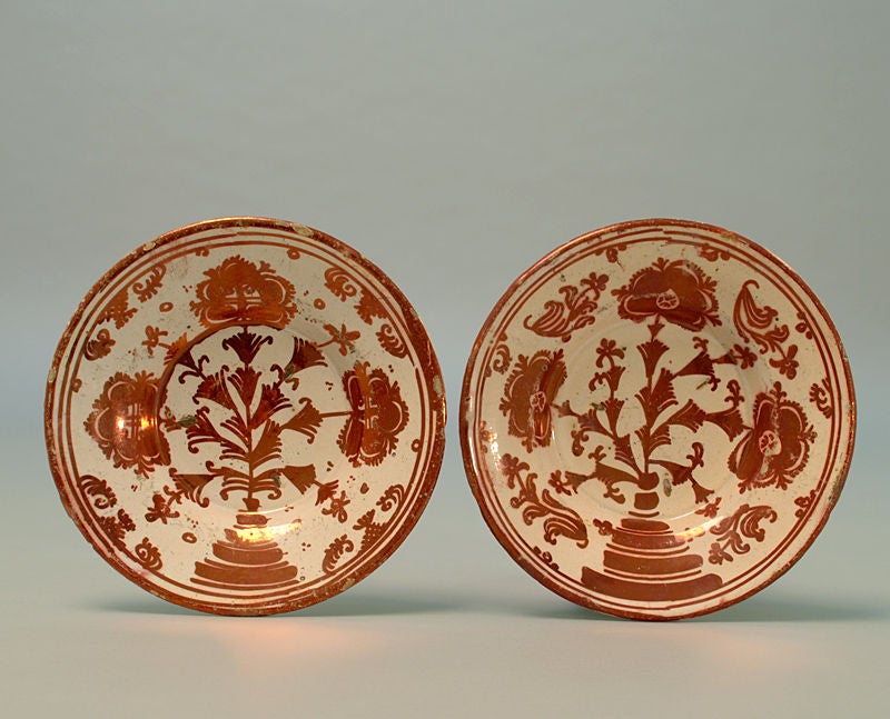 A pair of exceptionally fine 18th century Hispano Moresque luster plates with foliate motifs in deep copper over a milk white slip. Valencia (Manises) - circa 1750.<br />
<br />
Dimensions: 7.75 inches diameter.<br />
<br />
Condition: small rim
