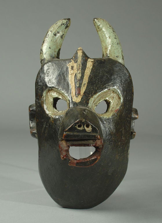 A good, large early 20th century (circa 1900) Nepalese cow mask from the Terai region in Southern Nepal. Carved and polychrome painted wood with protracted nose and painted horns.<br />
<br />
Dimensions: 12.5 inches high.