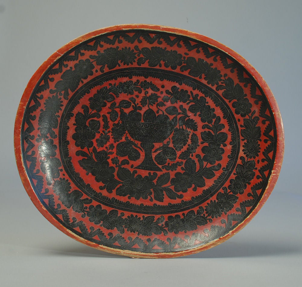 A very good, graphic early 20th century Mexican batea with a large urn surrounded by incised foliate motifs. Olinala, Mexico - circa 1930. <br />
<br />
Dimensions: 17.5 inches x 15 inches.