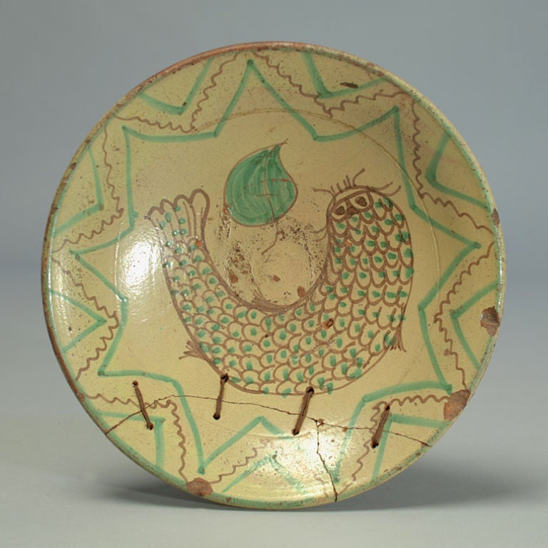 A large 19th century Andean maiolica bowl with a large catfish surrounded by a nine point star. Please note the unique woven wire repair.<br />
<br />
Dimensions: 10.5 inches diameter.