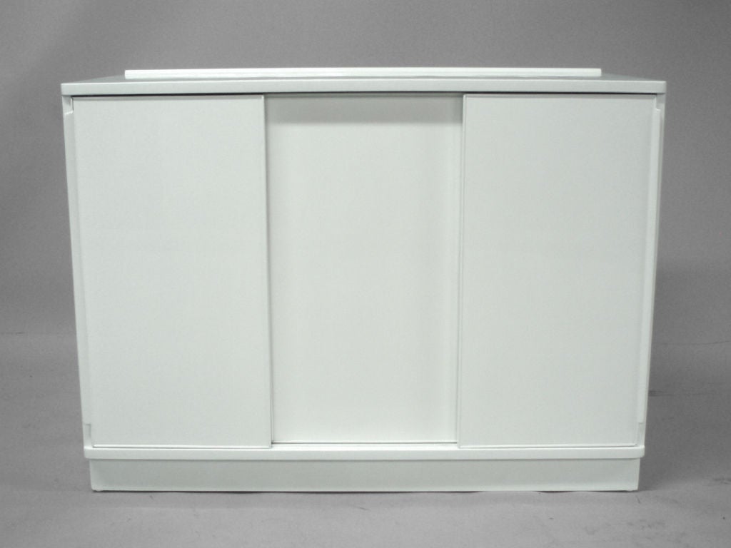 A White Lacquered  Sliding Door Cabinet by Edward Wormley for Dunbar.