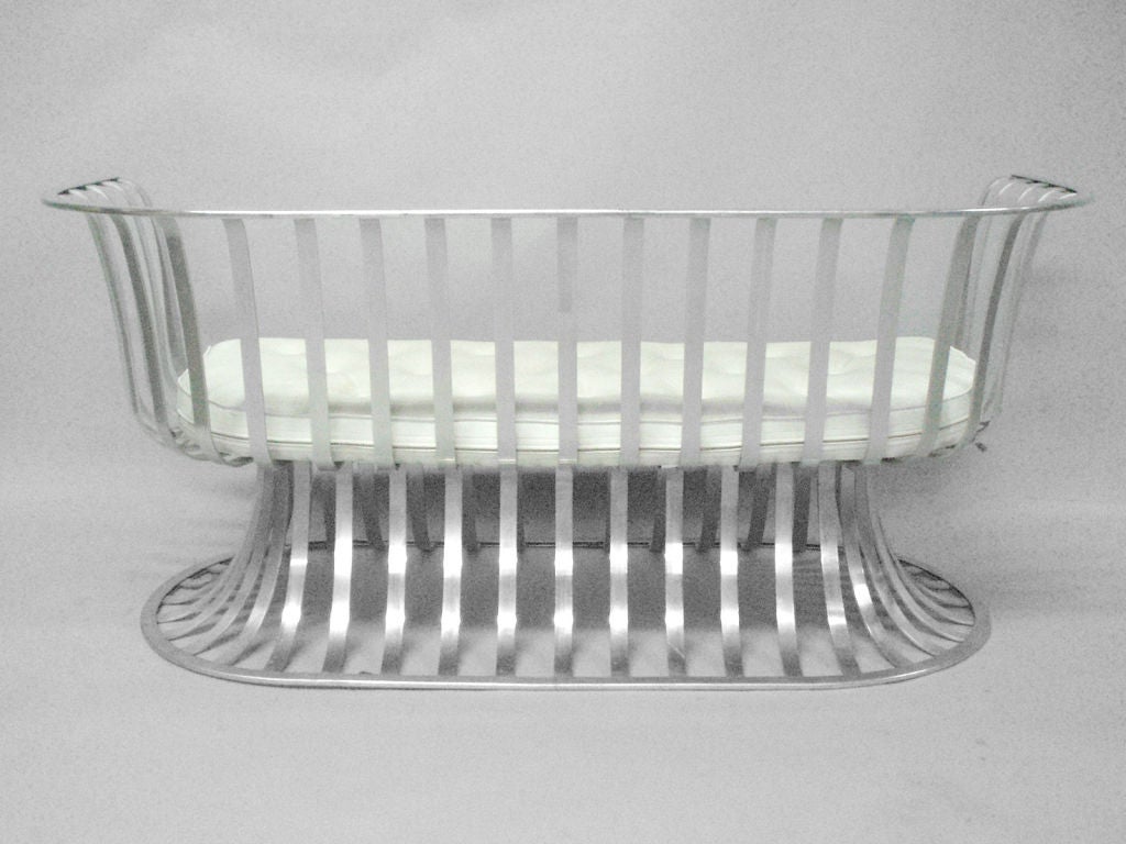 A curved aluminum frame settee with original upholstery by Herbert Saiger for the Lee Woodard Co.