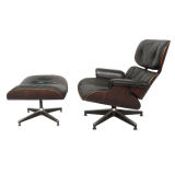 A Rosewood Lounge Chair with Ottoman by Charles 
Ray Eames