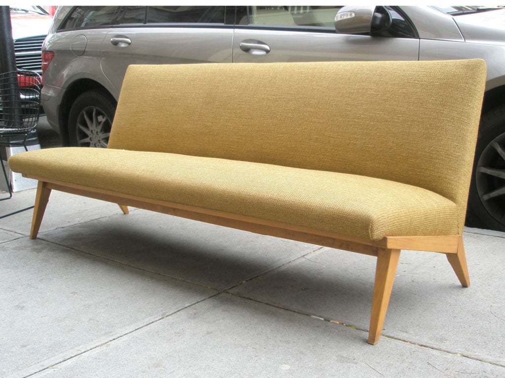 Mid-20th century armless sofa designed by Jens Risom for Knoll. Birch base and beige woven upholstery.