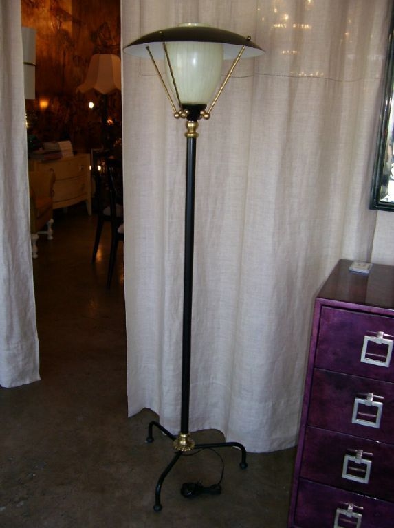 1950s tripod floor lamp with brass details and iron frame.