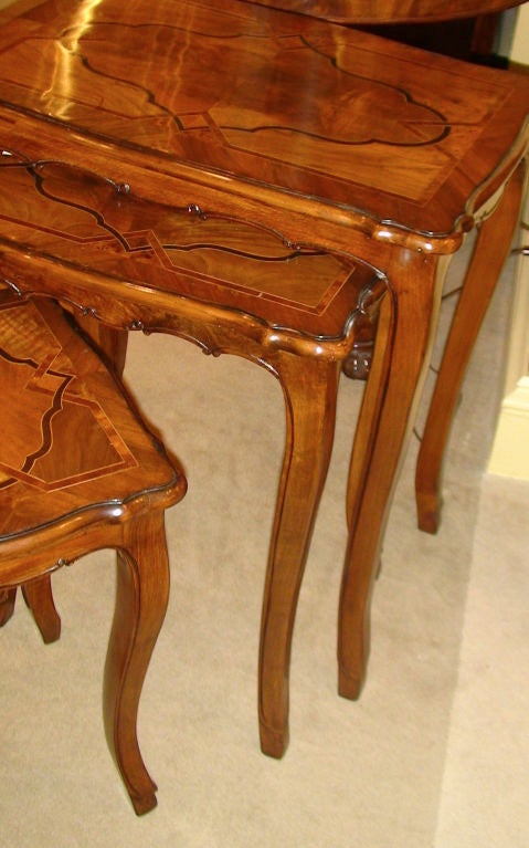 An exquisite Italian Walnut Inlaid Nest of Tables