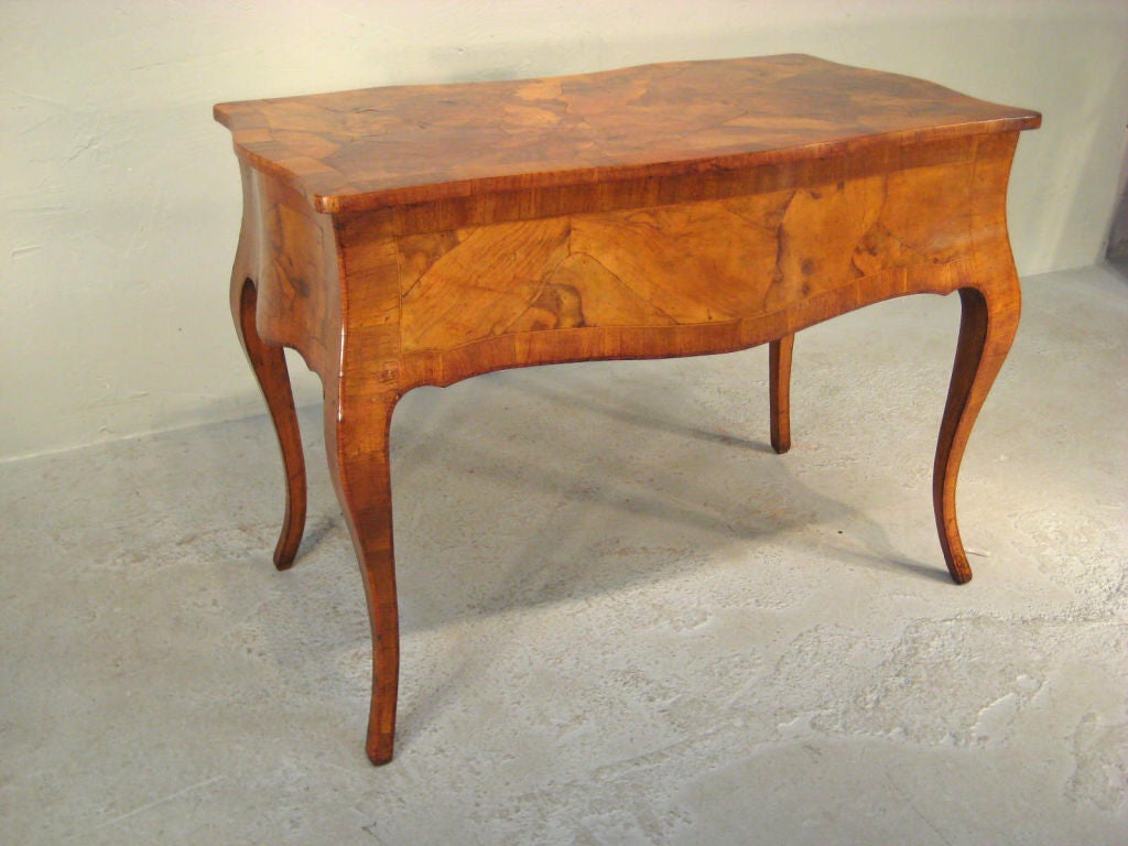 Fine Italian walnut and olive wood desk with five drawers and original brass pulls in the French Louis XV style.