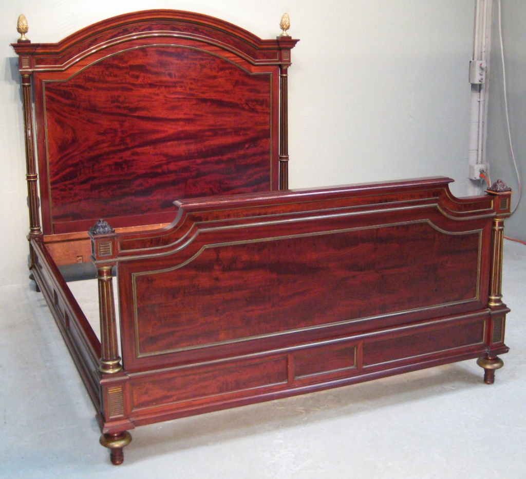 Regal French bed frame, made of mahogany with brass inlay and finials. Mattress size: 59