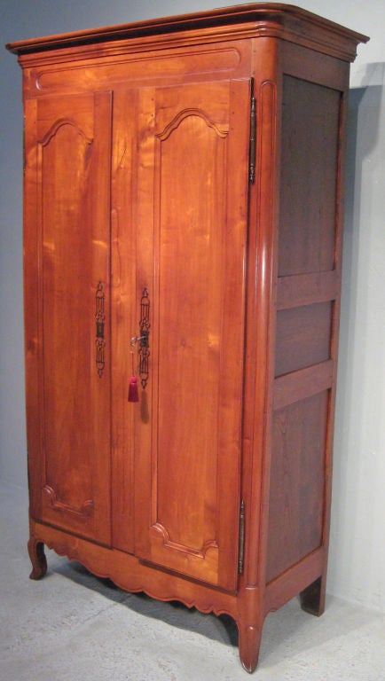 A superb armoire from the Normandy Province, made of cherry and chestnut with two inside shelves and dovetailed drawers. One old scratch on left side. More French Antiques at www.ofleury.com