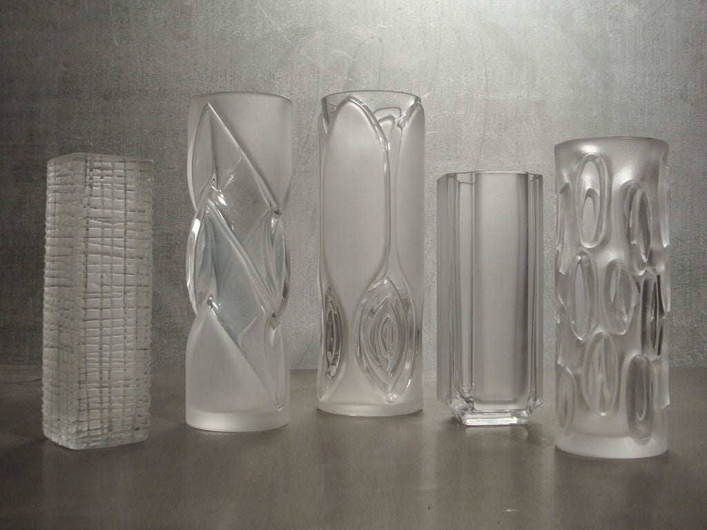 leaded, cut glass vases in various sizes and textures, priced individually.