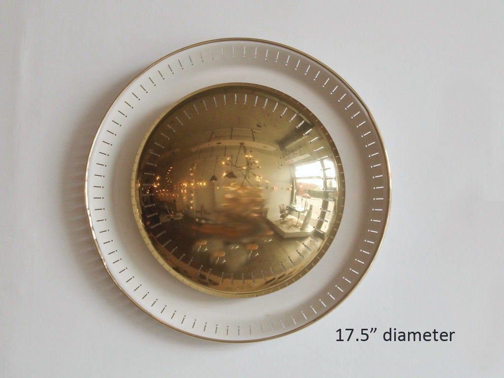 two enameled metal and brass disk wall lights<br />
larger: 17.5