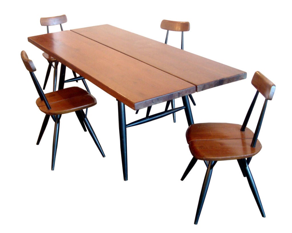 table and 4 chairs by Laukaan Puu<br />
split seat chairs and table in patinated dark brown pine tone ebonized dowel legs and frame<br />
original finish, burned signature on all<br />
table: 71 x 31.5 x 26.5 inches<br />
chairs: 15 x 15.5 x