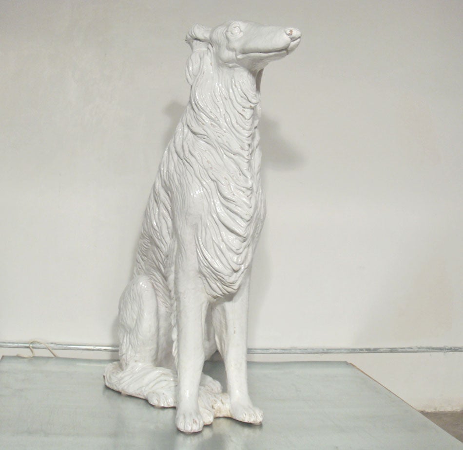 very large [and extremely heavy] glazed ceramic dog<br />
we have not yet found the breed of this regal hound...<br />
it bears resemblance to an afghan [or a long haired greyhound]<br />
...phenomenal...<br />
UPDATE:  Borzoi [Russian Wolfhound]