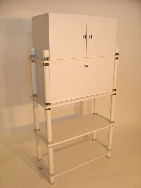 Laminate Storage Unit with Chrome accents. The Storage Unit has a drop down area and a concealed unit for storage. Two open shelves.