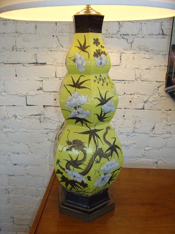 Attractive stacked pagoda style Chinese porcelain lamp. Vibrant yellow background decorated with flowers, foliage and dragons.Shade not included.
