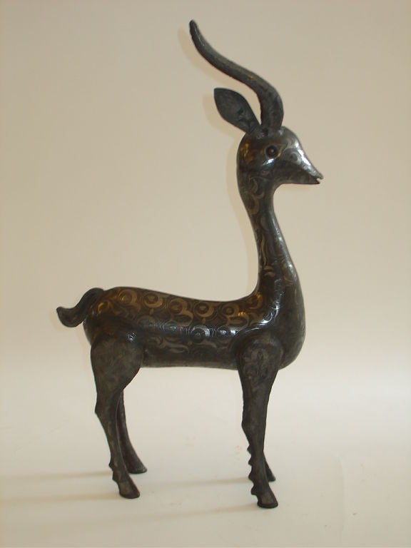 Highly sculptural metal deer from India. Very interesting Indian style overall surface design.