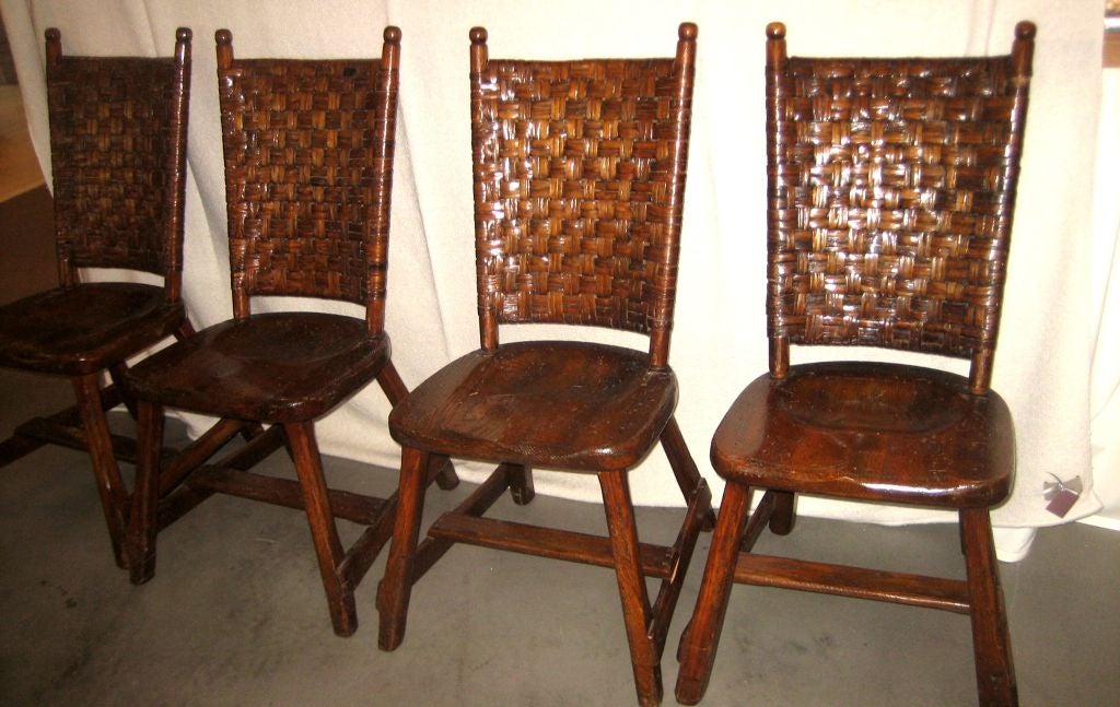 set of four Old Hickory side chairs; original finish;  wood seats with split cane woven backs;  stretcher between lower legs;  mark on undersiide of seats
