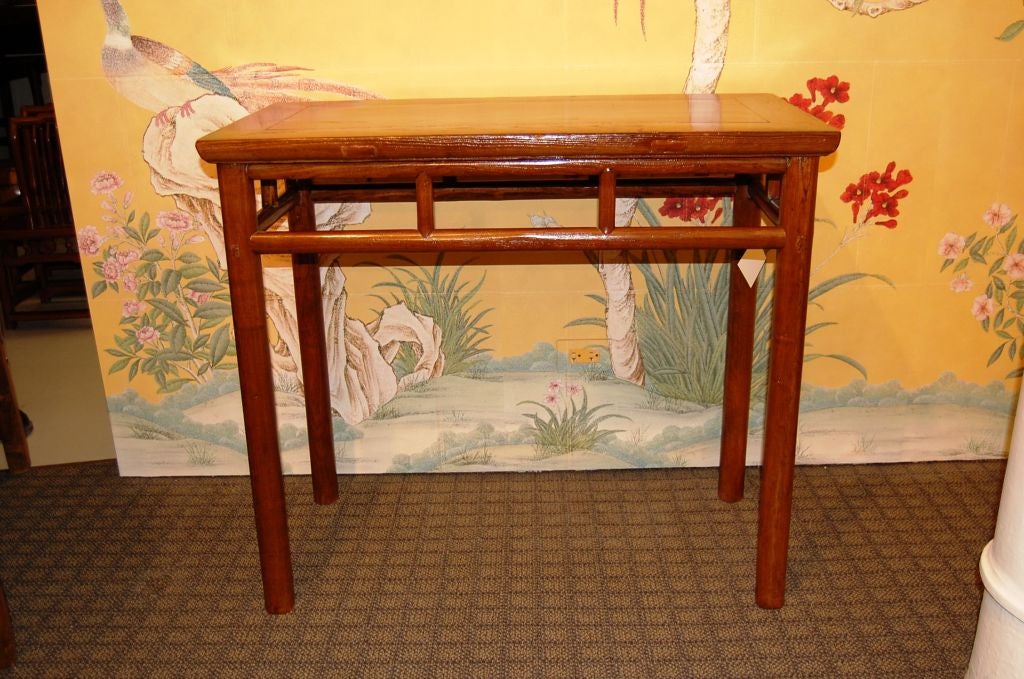 A graceful pair of 18th century side tables made of elmwood.<br />
<br />
With vertical bracing in the aprons of each table.  <br />
<br />
Simple lines, and round legs.