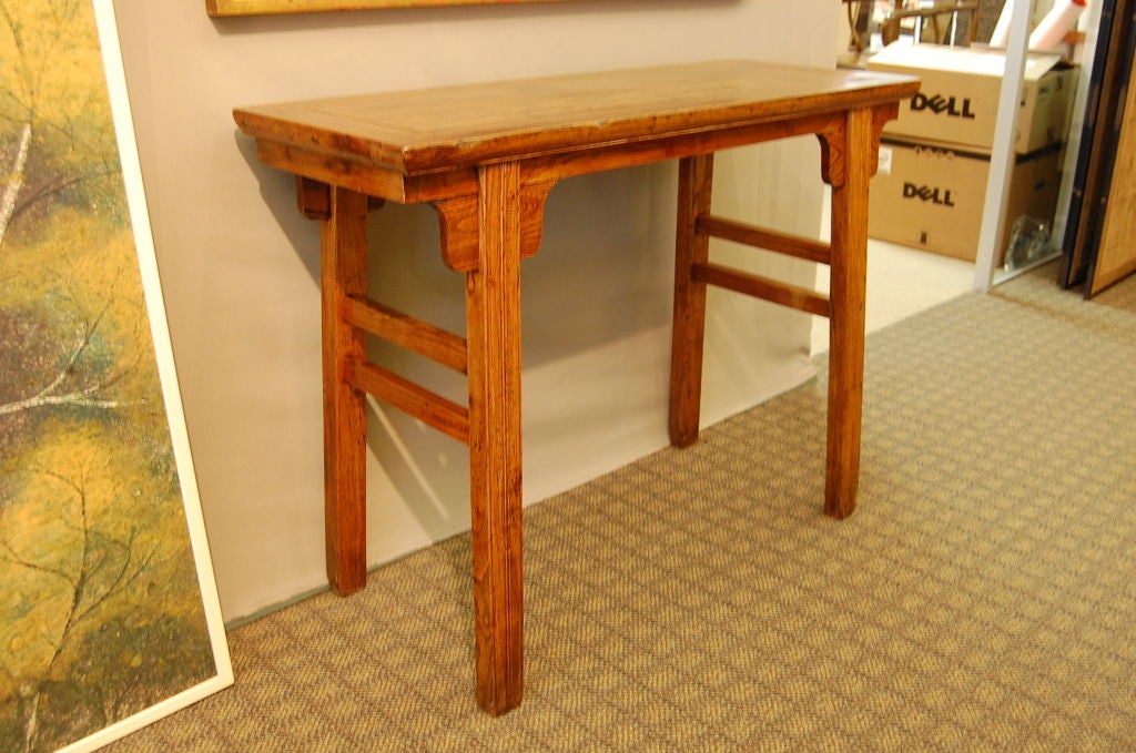 A simple and elegant small elmwood side table from the 18th century. This table would be the perfect size for a hall table. The wood has beautiful patina, and the legs, apron and stretchers are in good condition.