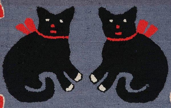 Late but great, this ca 1940-1950 American hooked rug features two black cats with red bows, in mirror images poses, flanked by four red hearts, one in each corner. This is surrounded by a scalloped border. The colors are black, grey, red and