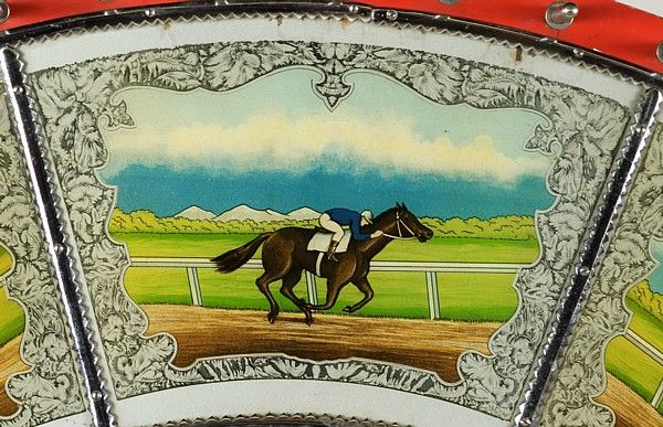 RACE HORSE GAME WHEEL, CA 1930-50, made by EVANS, CHICAGO:<br />
<br />
Elaborately embellished race horse gaming wheel, made by Evans & Company in Chicago. Each of the wheel's 10 panels are brightly colored lithographs behind glass, framed by