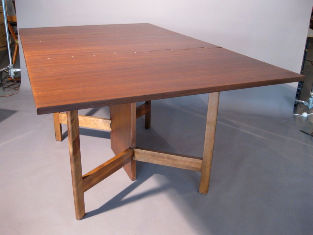 Gate leg walnut dining table with two drop leaves designed by George Nelson for Herman Miller in 1946. Table can be used by opening only one leaf or the two together. Legs with prominent zebra graining in wood.  Dimensions fully open: 40