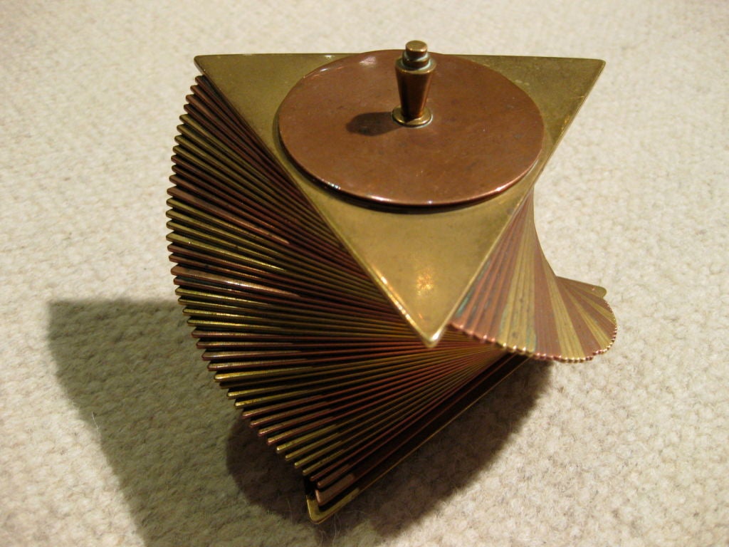 One of the iconic American art deco designs in the form of a brass and copper cigarette box c.1929 impressed with the name 