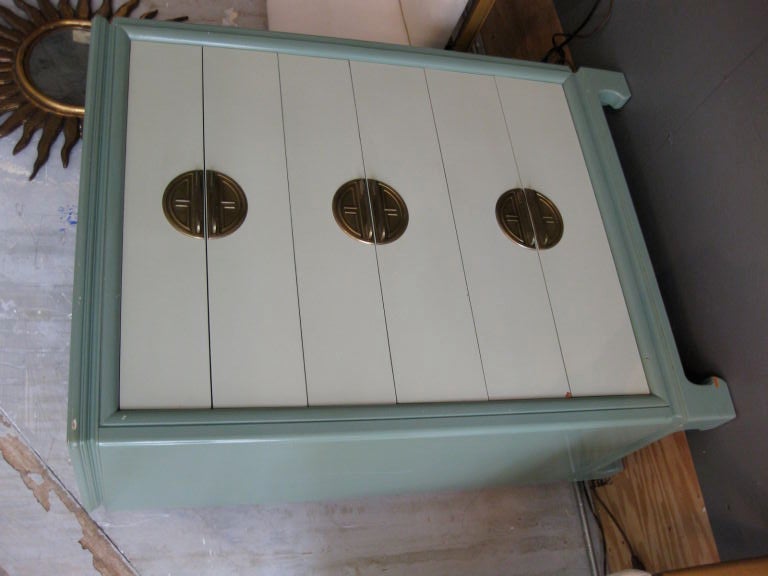 Six drawer chest in the Asian Modern style with brass chinoiserie handles mfg. by Kittinger in the 1940's. Original pale green and off white lacquer finish.

WEEKLY DELIVERIES TO MANHATTAN FOR APPROVAL OR SALES. DELIVERY FEE IS $150.