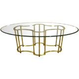 An Oval Top Glass and Brass Dining Table by Mastercraft