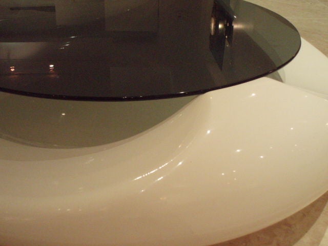A round molded plastic cocktail table featuring a white body with a black glass top. By Astarte, Milan Italy circa 1965. Table has its original label on the base.