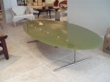 A Mid-Century Oval Glass Topped Cocktail Table