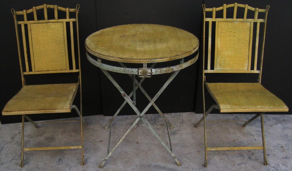 Outstanding Faux Stiched Leather Campaign Table and 2 Chairs. Both the Table and 2 Chairs collapse.  The entire set is metal.<br />
Measurement on the Chairs is 34
