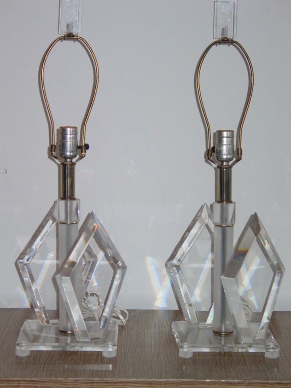 Fun lozenge shaped blades of Lucite flank the stem of these lamps.  Completely original, including finials.  Silver lined recent shades included if you wish.
