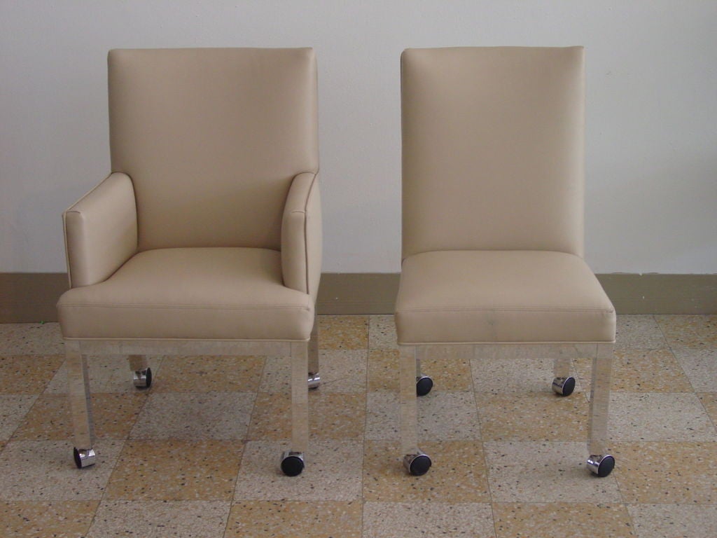 Eight Dining Chairs, including two armchairs and six sidechairs with simple polished aluminum parsons style bases.  Original casters, all in good order.