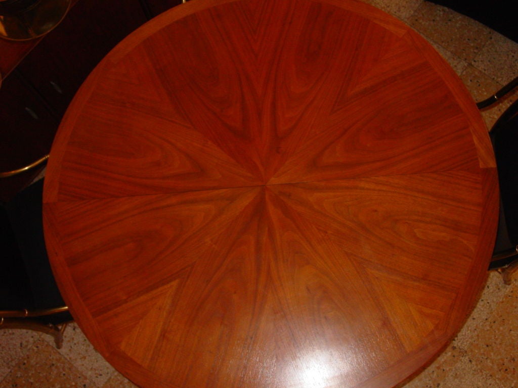 Elegant small-scale extension dining table with banded, book-matched, starburst pattern top. Two matching 18