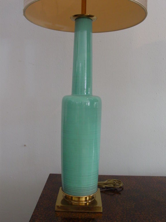 Fabulous brass mounted pottery lamps by Stiffel. Rare turquoise and burgundy colorway. Original harps and finials.  Price is for taller lamp, shorter lamp is $1550