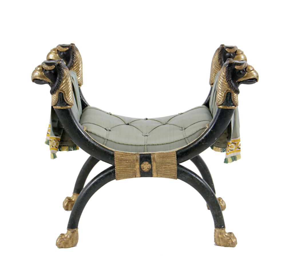 Fine Regency giltwood and painted upholstered X-frame stool with griffin head monopodia supports, bundled reed clasp and paw feet, based on a design by Thomas Hope