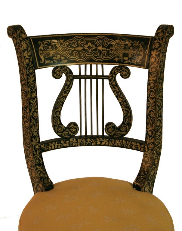 A rare Regency penwork decorated musician's chair with pierced lyre-form back above circular, adjustable height seat.