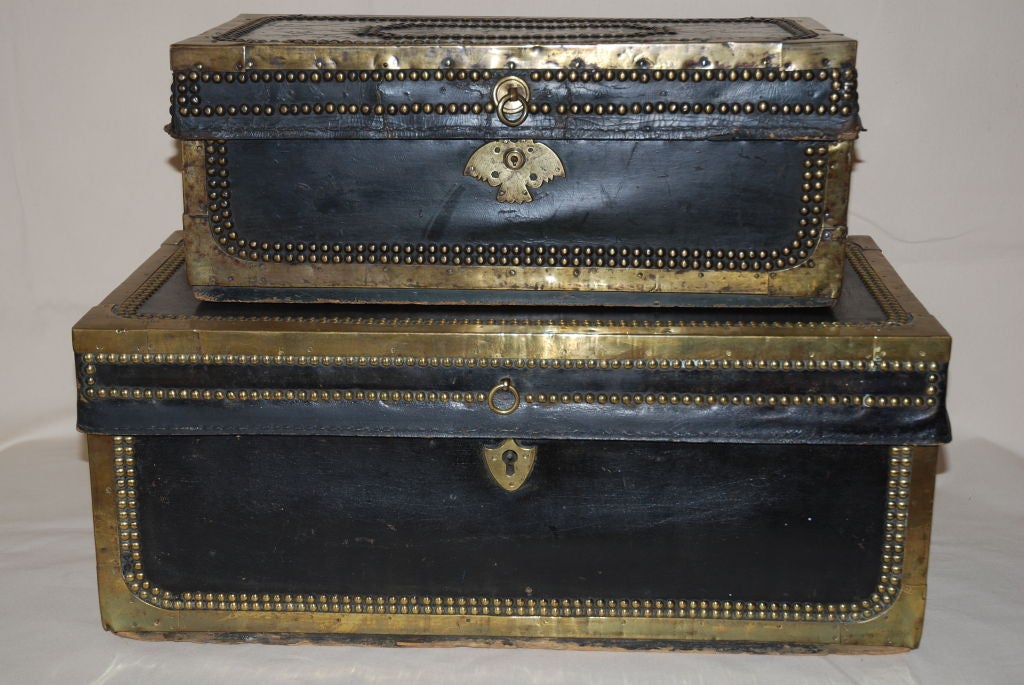 A suite of nineteenth century, Chinese export, leather bound, brass studded, traveling trunks, lined in camphor wood.