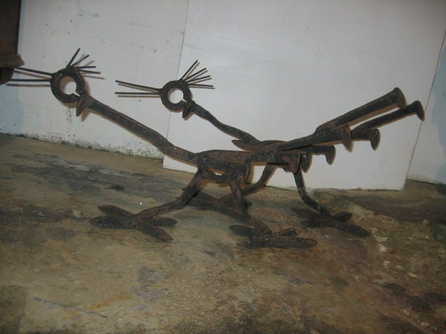 Unique hand-forged iron roadrunner fire dogs. Welded from scrap iron and hand-forged nails. Wonderful Southwest style for ranch house or cabin.