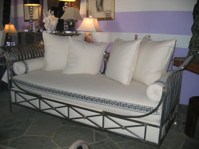 French Campaign Daybed by Maison Jansen. Neoclassically inspired in original condition. Steel framing with bronze details. Newly upholstered with embroidered trim. Four throw pillows and two bolster pillows.