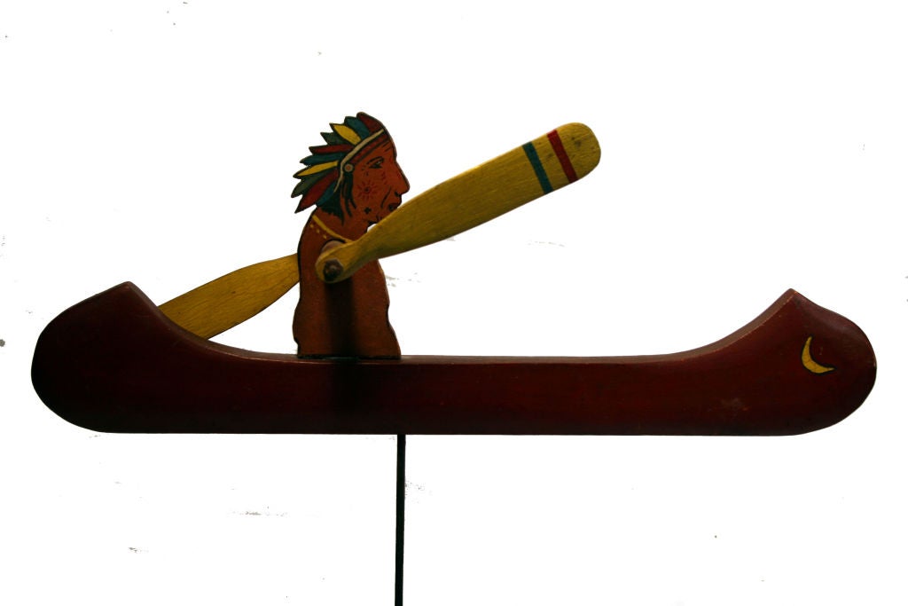 This whirligig is a beautiful example of American folk art. It depicts an Indian chief in a bright red canoe with yellow paddles. Whirligigs were used as a creative way to keep unwanted animals out of the garden. They are also known as 