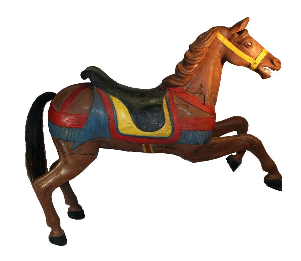 This gorgeous carousel horse once belonged to a summer camp in Glen Spey, NY. The camp owners acquired the whole merry-go-round in 1940 at an auction. It is attributed to Charles Looff of New York or C. W. Parker of Kansas.<br />
<br />
Charles