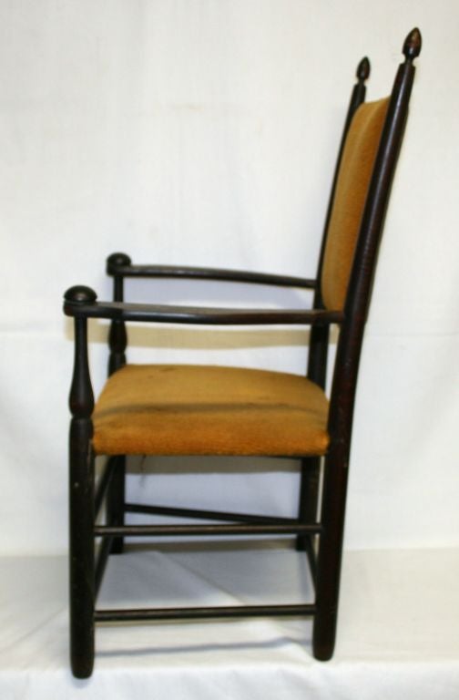 This gorgeous child's chair was made at the Mt. Lebanon Shaker Community in New Lebanon, New York. It is built of curly maple with a dark mahogany finish, and has a rare mustard wool cushion seat and back. <br />
<br />
Provenance: The chair