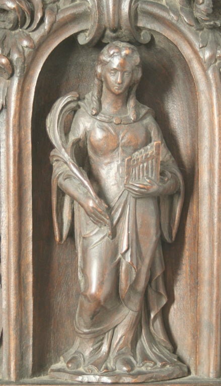 This is a truly spectacular carving, meant to be mounted on a wall, of St. Cecilia. It is Italian, and dates from the late 17th or early 18th century. St. Cecilia is the patron saint of music and of the blind. In this depiction, Cecilia holds an